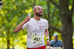 5x5 km TEAM-Staffel: Männlicher Läufer schüttet sich aus einem Becher Wasser ins Gesicht © SCC EVENTS / Kai Wiechmann