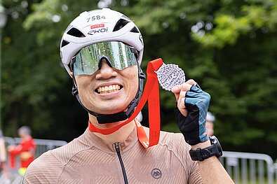 Cyclist is happy about his medal 